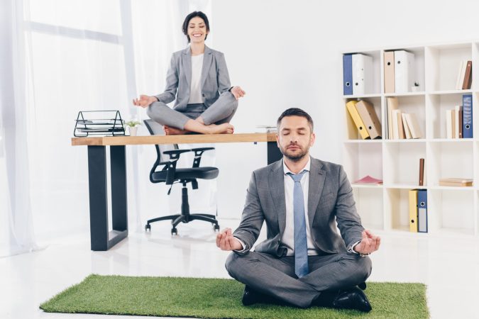 businessman-meditating-on-grass-mat-while-business-2024-11-17-10-39-28-utc