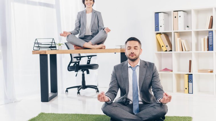businessman-meditating-on-grass-mat-while-business-2024-11-17-10-39-28-utc