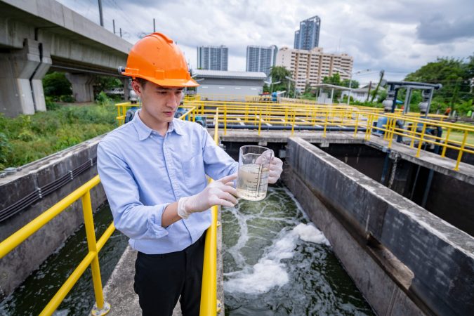 engineer-take-water-from-wastewater-treatment-pond-2025-03-13-19-23-47-utc