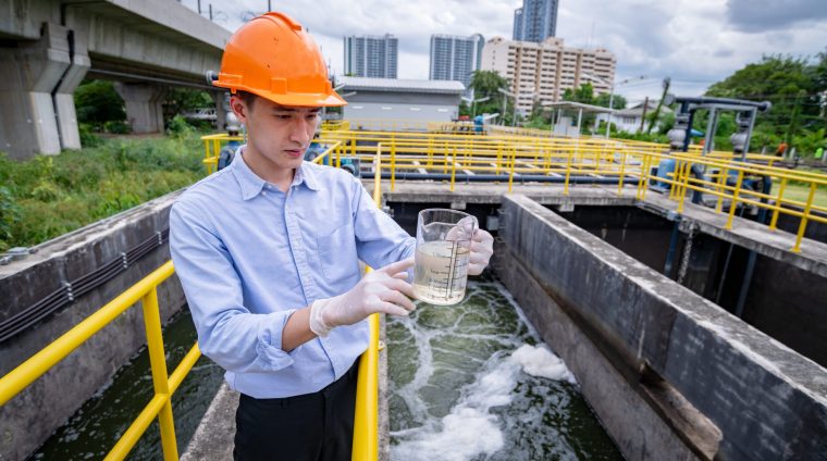 engineer-take-water-from-wastewater-treatment-pond-2025-03-13-19-23-47-utc