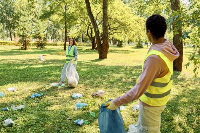 harmony-in-green-diverse-couple-cleaning-park-2024-11-07-18-11-19-utc