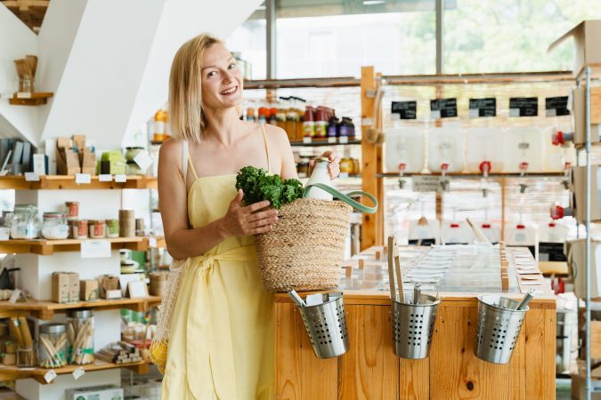smiling-woman-buying-organic-food-and-eco-products-2025-03-09-01-39-57-utc