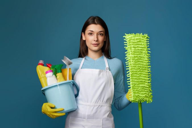 woman-in-cleaner-apron-holding-bucket-of-detergent-2024-10-19-19-59-36-utc